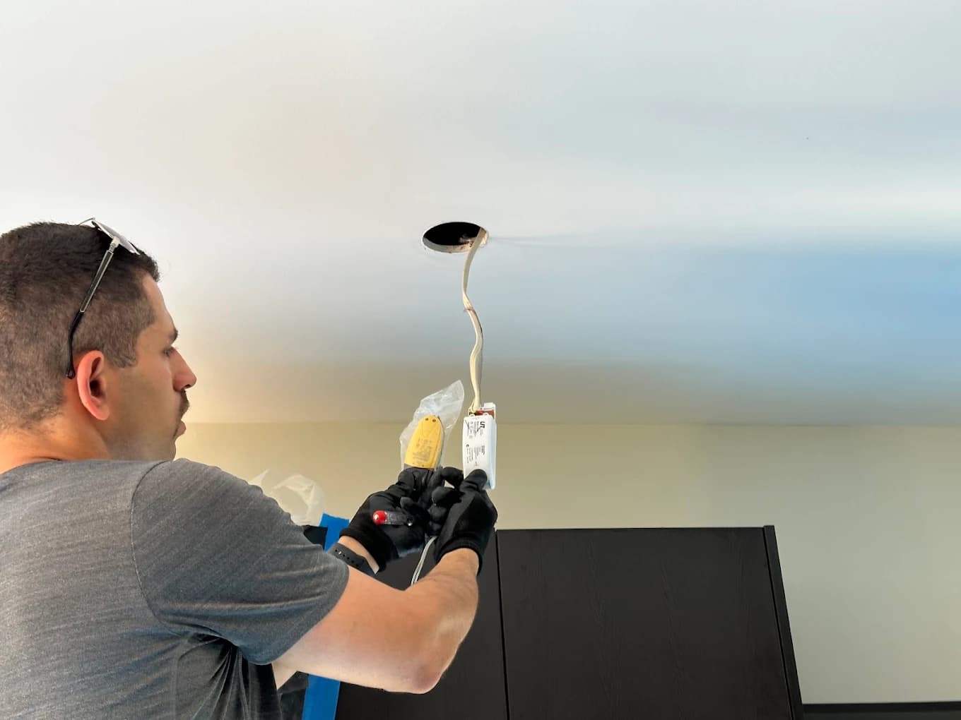 Mark wiring a downlight into a plasterboard ceiling